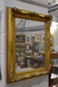 A gilt framed mirror.