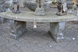 A composite garden curving bench seat with supports.