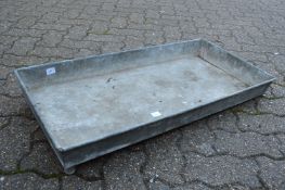 A rectangular galvanised trough or planter.