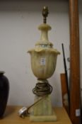 A large urn shaped alabaster table lamp.