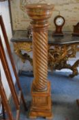 A pair of pine pedestal columns with wyrthen fluted column on a stepped square base.