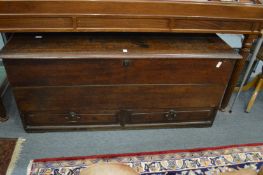 A 18th century oak coffer with loose top and two drawers.