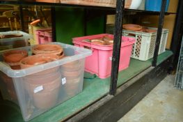 A quantity of terracotta flower pots.