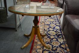 A yew wood oval coffee table.