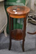 An Edwardian inlaid mahogany two tier jardiniere stand.
