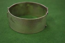 A silver bangle.