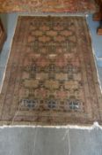 A Persian rug, early 20th century, brown ground with stylised decoration (worn) 180cm x 115cm.