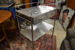 A stainless steel two tier two drawer trolley.