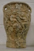 A large relief moulded pottery vase.