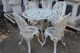 A white painted aluminium circular patio table with four chairs.