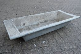 A galvanised rectangular planter/trough.