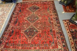 A Persian design carpet, red ground with stylised animal and bird decoration 215cm x 180cm.