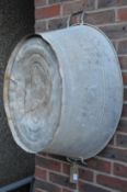 A large galvanised twin handled tub or planter.