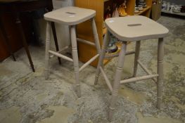 A pair of painted bar stools.