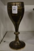 An engraved brass goblet.