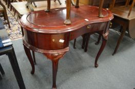 A mahogany stained kidney shaped side table.