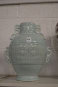 A Chinese pale turquoise ground vase with pierced handles and moulded decoration.