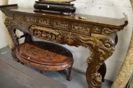 A large Chinese carved and gilded scroll end altar table.