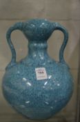 A Chinese turquoise glazed twin handled pottery vase.