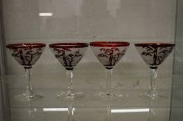An unusual set of four cocktail glasses with engraved and etched decoration.