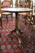A George III design mahogany tilt top tripod table with carved pie crust border, fluted column on