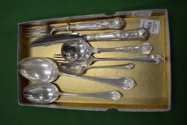 A group of silver flatware.