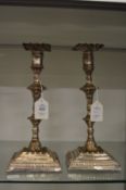 A pair of Sheffield plated candlesticks.