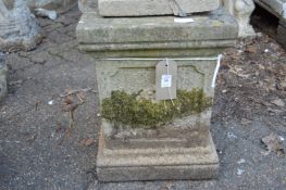 A pair of composite square shaped garden pedestal stands with moulded decoration.