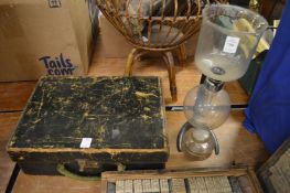 An old Cona coffee machine and a leather case.