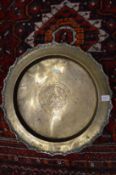 An engraved Eastern brass circular dish.