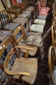 A 19th century elm dining chair with arms together with three matching single chairs (one af) and