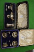 Two cased silver condiment sets.