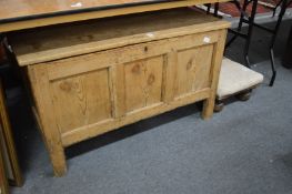 A pine coffer and an upholstered stool.