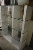 A large modern glass and laminated room divider/display unit.