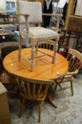 A pine circular table, five various chairs.