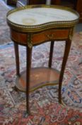 A French ormolu and marble top mahogany two tier single drawer kidney shaped occasional table.