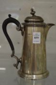 A silver hot water jug.