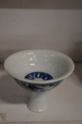 A Chinese blue and white decorated porcelain stem cup.