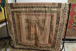 A good large flat weave kilim carpet with all-over stylised decoration (some ware and holes) 385cm x