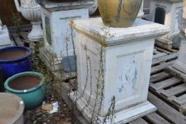A pair of white marble square shaped plinths.