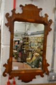 A walnut framed fretwork mirror.