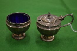 A silver mustard pot and matching salt.