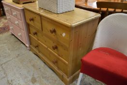 A pine chest of drawers.