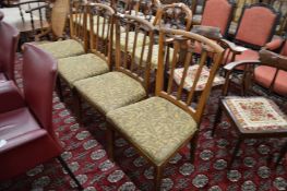 A set of four elm framed and upholstered dining chairs.