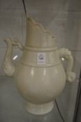 A Chinese buff glazed pottery ewer.