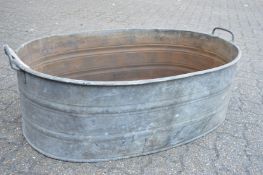 A large galvanised twin handled oval garden planter.