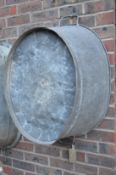 A large galvanised twin handled tub or planter.