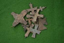 A collection of small bronze crucifix's.