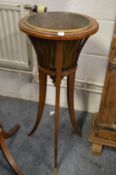 An Edwardian inlaid mahogany jardiniere with brass liner.