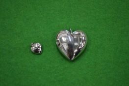 Two stainless steel heart pendants.